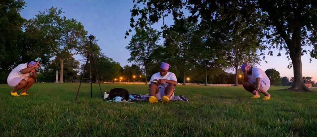 writing in a park, duplicated 2 other selves on the picture