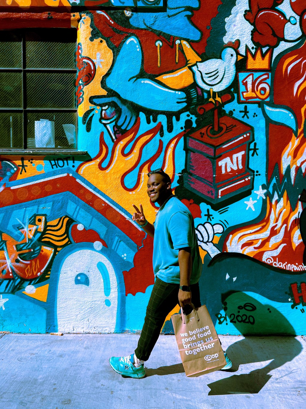 walking past a mural in San Francisco