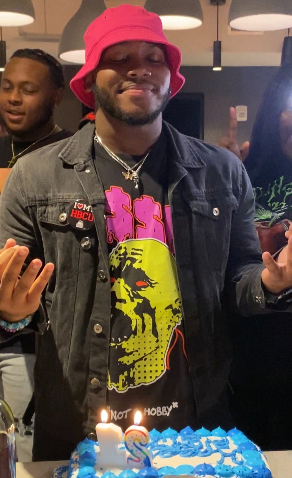 colonel-joshua higgins celebrating his birthday in meditative pose over his birthday cake